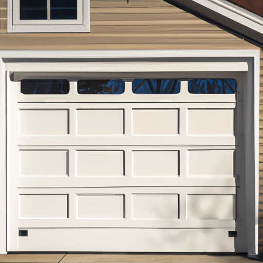 Insulated sectional garage door with sealed threshold and windows on a suburban Wellesley, MA home in morning light.