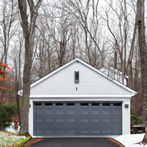 Closed insulated modern garage door on a suburban Wellesley, MA home with light snow on the driveway and nearby trees.